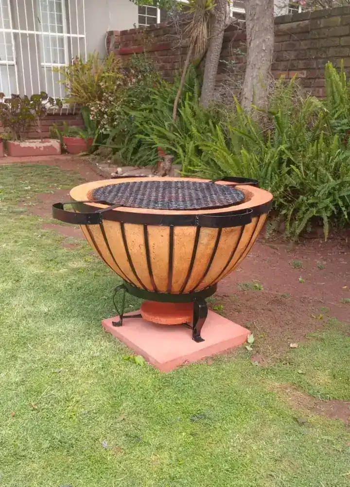 Firepit and braai boma in a green garden