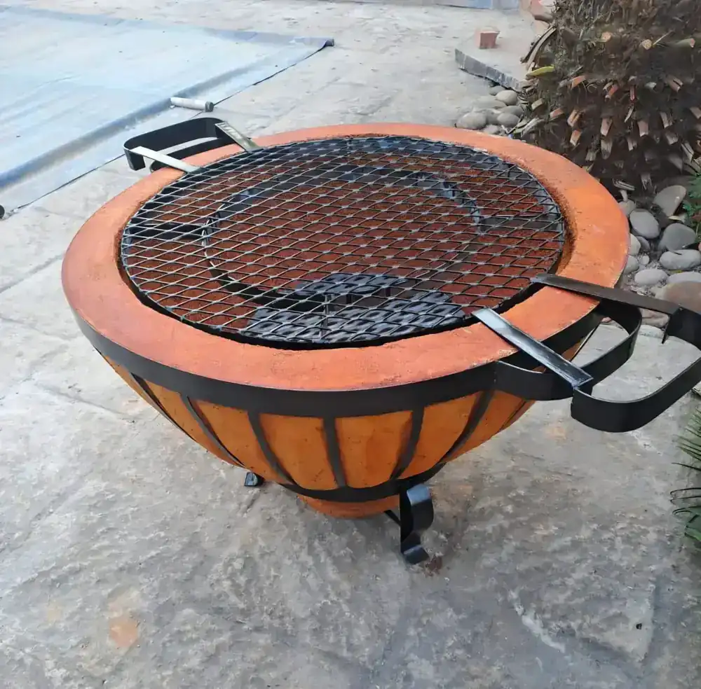 Handcrafted round firepit with steel cooking grid